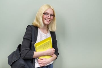 Portrait of happy student girl teenager 16 years old in glasses with backpack