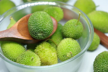 Fresh green colorful spiny gourd or teasel gourd vegetables on white background