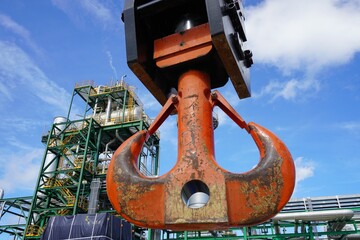 Close up crane hook for mobile crane in factory and background is a chemical plant Industrial estate.