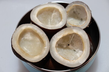 Close up view of dried coconut chips on white background in india