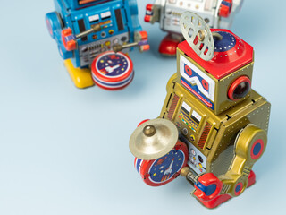 Three robot tin toy on blue background.