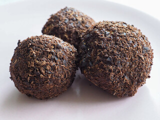 Chocolate balls on white background.
