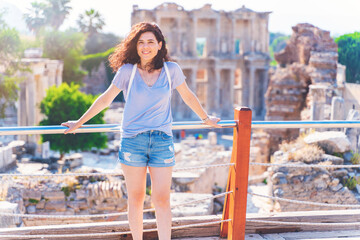 Tourist woman is traveling in a sunny winter day in Ephesus / Efes Selcuk Izmir Turkey - obrazy, fototapety, plakaty
