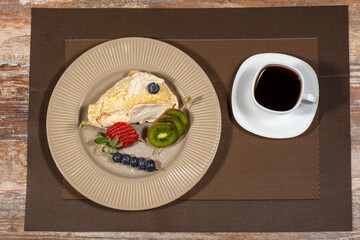 Fototapeta na wymiar cake with raspberries and cup of coffee on a wooden table