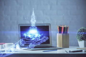 Desktop computer background in office and start up theme hologram drawing. Double exposure. Startup...
