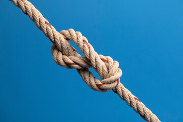 Rope with a knot on blue background
