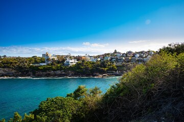 Fototapeta na wymiar Gordons Bay surrounded by high rock cliffs and houses, turquoise blue waters great for swimming Sydney NSW Australia