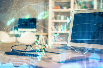 Financial graph colorful drawing and table with computer on background. Multi exposure. Concept of...
