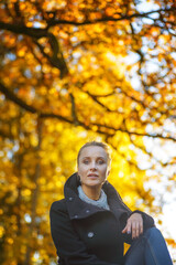 Beautiful woman posing in a autumn park