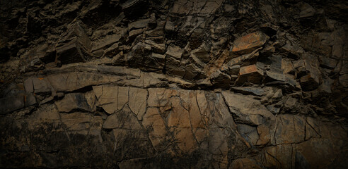 Dark grunge background. Stone background. Brown rock texture. Close-up. Rusty background.
