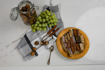 Assorted homemade cakes stage with grapes and nuts. Top view, flat lay