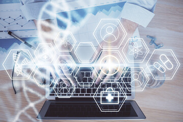 DNA hologram with businessman working on computer on background. Concept of bioengineering. Double exposure.
