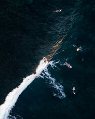 Aerial photo of a man surfing in Siargao island, Philippines.
