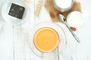 Tea and fresh milk in a beverage glass on the table