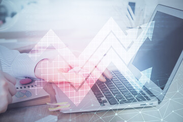 Growing arrows with businessman working on computer on background. Success concept. Double exposure.