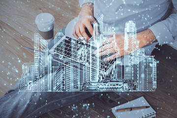 High tech city drawing with businessman working on computer on background. Smartcity concept. Double exposure.