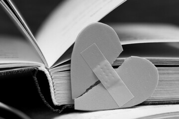 Band Aid Covering Heart and open book, black and white