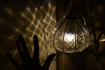 Lamp included, shadows on the wall and a child's hand in the night.