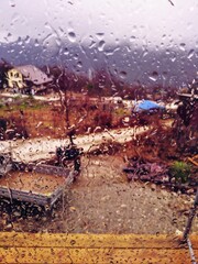 close-up photo of raindrops on a window with a wet view of Sochi