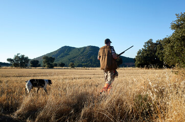 Hunter with dog at field