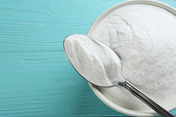 Baking soda on blue wooden table, top view