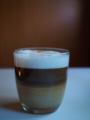 picture of a cup of coffe with milk into a white table
