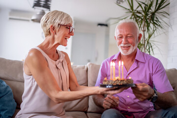 Senior couple celebrating at home.