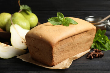 Tasty pear bread and mint on black wooden table, closeup. Homemade cake