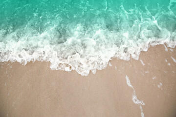 Fototapeta na wymiar Beautiful view of sea tide on sandy beach. Summer vacation