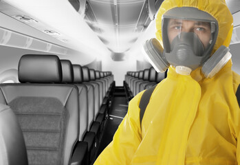 Man wearing protective suit cleaning cabin in airplane to prevent spreading of Coronavirus