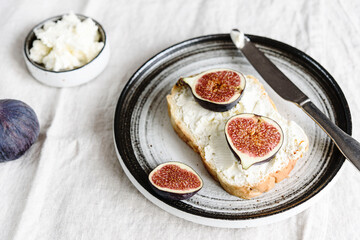 Sandwich with Ricotta and fresh Figs on natural linen tablecloth. Simple healthy breakfast