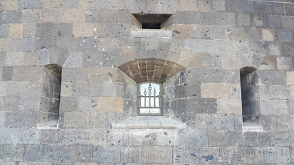 Naklejka premium A window with bars on the Old castle from the outside.