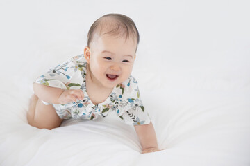 Fototapeta premium Baby Crawl ing on White Bed
