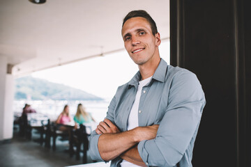 Confident casual man standing in cafe