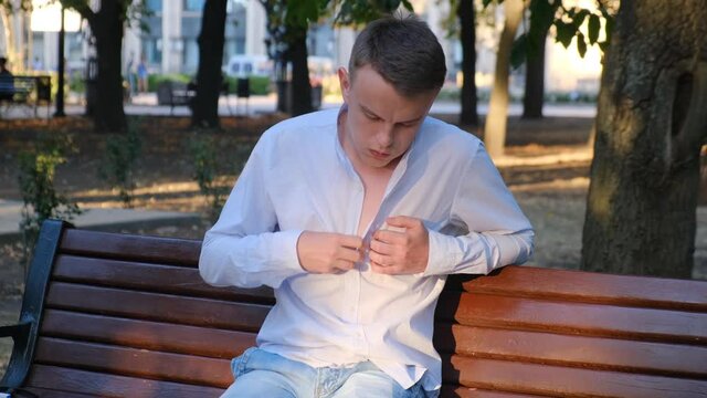 Young man felt sick on a park bench