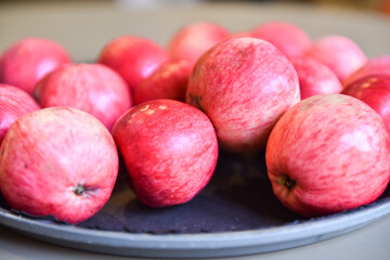 Delicious red apples in a plate on the table