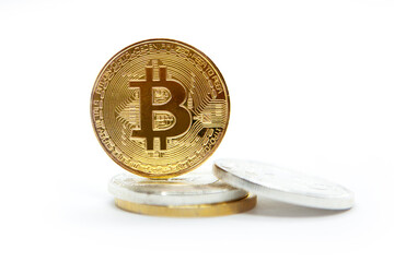 Bitcoin cryptocurrency standing on stacked coins. Isolated on white white background. 