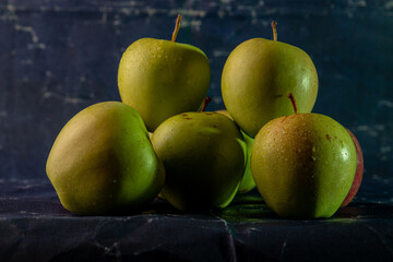 apples in a transparent vase on a blue background, one apple, three apples, fresh apples, red apple, green apple, yellow apple, bitten apple