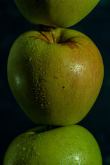 apples in a transparent vase on a blue background, one apple, three apples, fresh apples, red apple, green apple, yellow apple, bitten apple