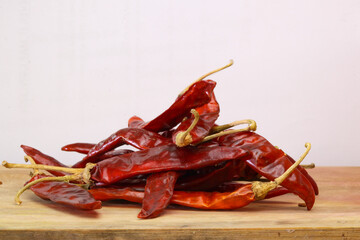Closeup Pile of air-dried red chili peppers background. Hot and spicy dry red chillies.