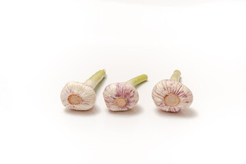 Three garlic with a stem on a white isolated background