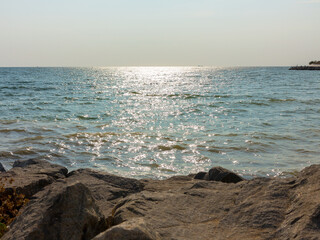 Panoramic seascape. View of sea and beach with stones at sunset in the evening, sea tide, natural photo, Odessa, Ukraine