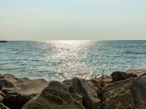 Panoramic seascape. View of sea and beach with stones at sunset in the evening, sea tide, natural photo, Odessa, Ukraine