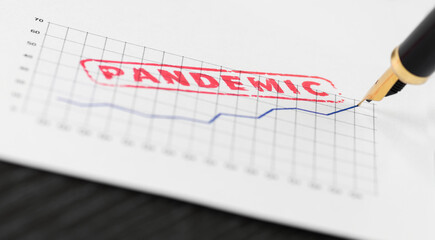 Macro shot of red stamp pandemic on a chart and fountain pen.
