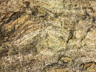 Stone background of mottled granite igneous rock used in construction, as a finishing material for kitchen countertops, etc.