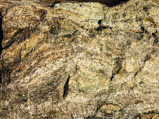 Stone background of mottled granite igneous rock used in construction, as a finishing material for kitchen countertops, etc.