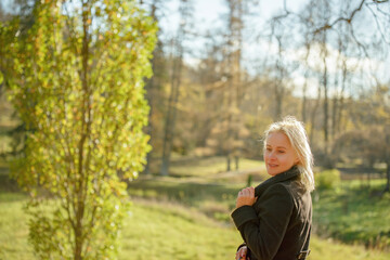 Outdoor fashion photo of young beautiful lady in a birch forest.