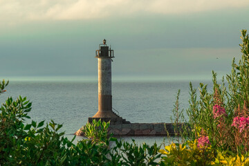 lighthouse on the shore of a lake