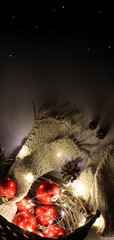 red Christmas balls and included garland in a wicker basket. warm atmosphere for Christmas