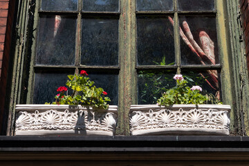 Fototapeta na wymiar Window Sill Outdoor Flower Planters with Colorful Flowers at an Old Home in New York City